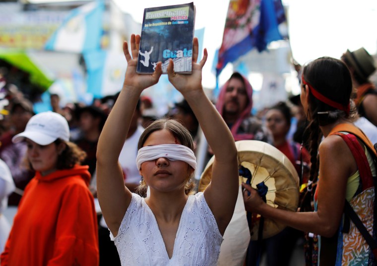 Demonstrators take part in a march to protest against the decision of Guatemala President Jimmy Morales to end the mandate of the U.N.-backed anti-graft commission (CICIG), in Guatemala City