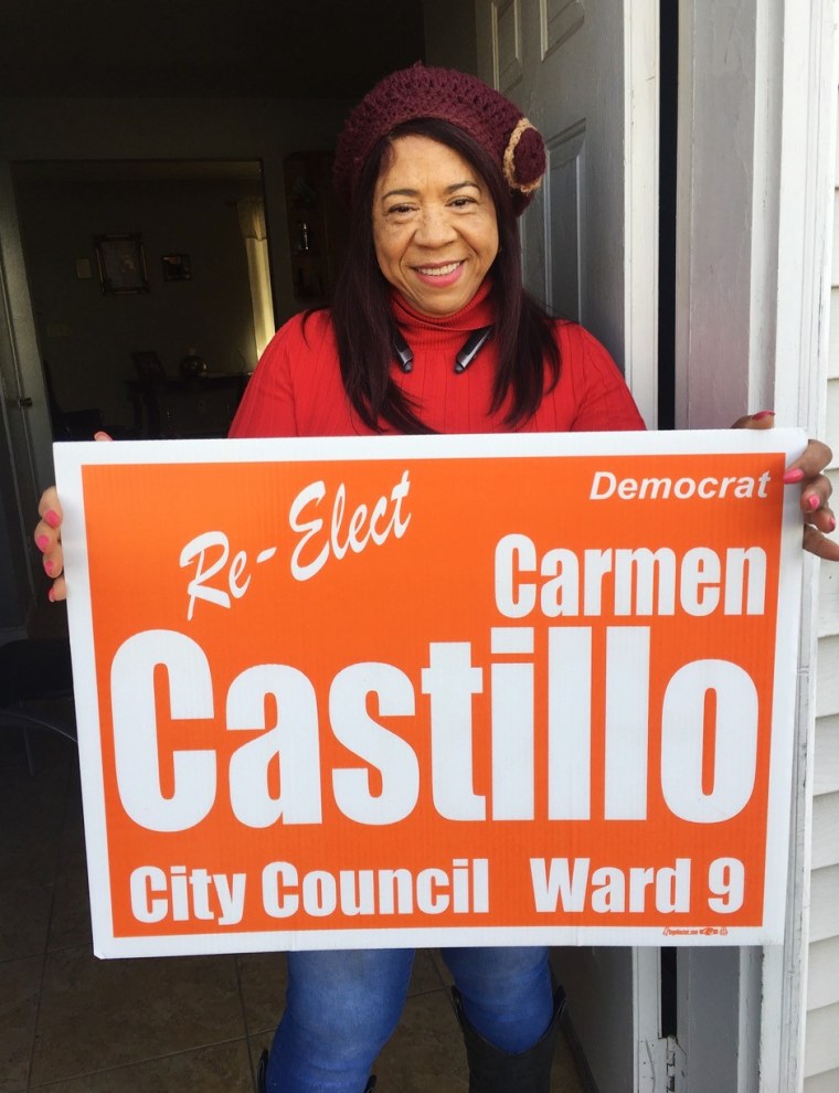 Carmen Castillo poses at home with a campaign sign