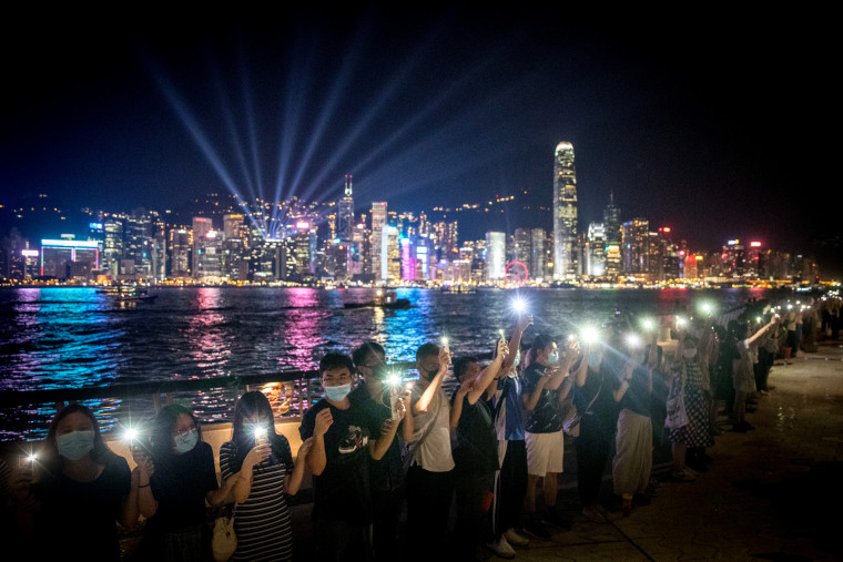 Image: Protesters hold hands to form a human chain along Hong Kong's Avenue of Stars on Aug. 23, 2019.