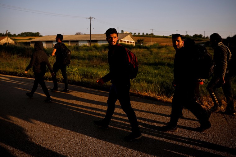 Image: A group of Syrian refugees who crossed the Evros river, the natural border between Greece and Turkey, walk towards the city of Didymoteicho, Greece