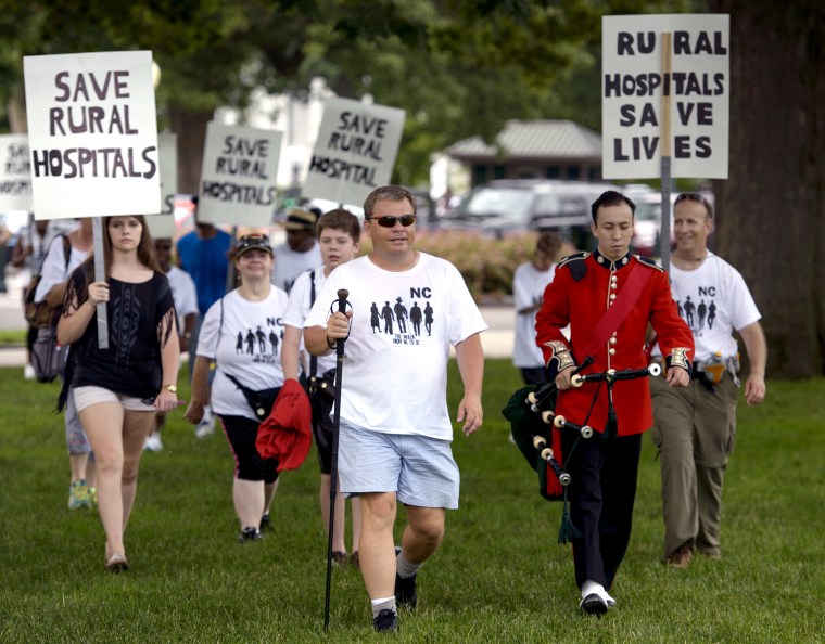 Mayor Adam O'Neal, of Belhaven, North Carolina, walks with supporters during a rally for rural hospitals on Capitol Hill June 15, 2015 in Washington, DC.