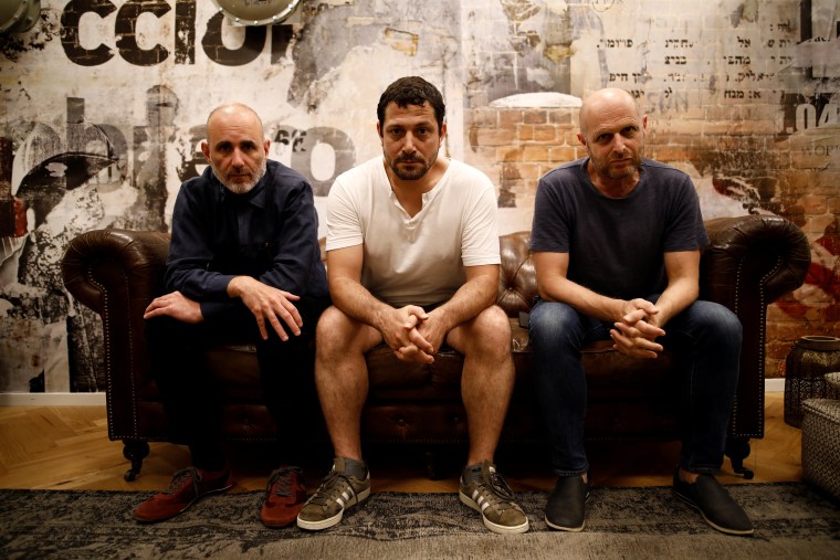 Image: Co-creators of HBO series "Our Boys", Hagai Levi, Tawfik Abu Wael, and Joseph Cedar, pose for a picture during their interview with Reuters in Tel Aviv