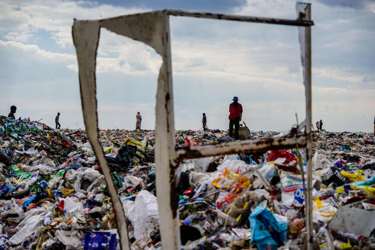 Image: Recyclers are seen scouring Richmond sanitary landfill site for material in Zimbabwe.