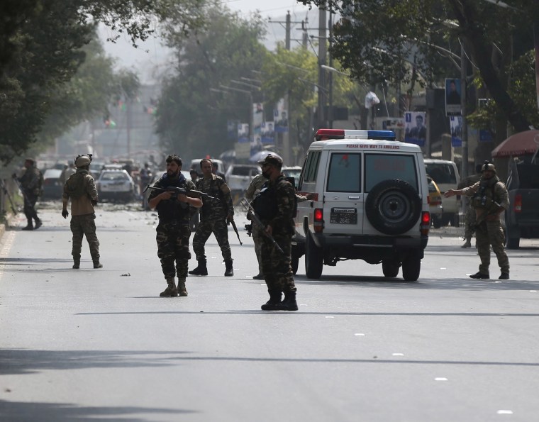 Image: Afghan security forces keep watch at the site of a suicide attack in Kabul, Afghanistan