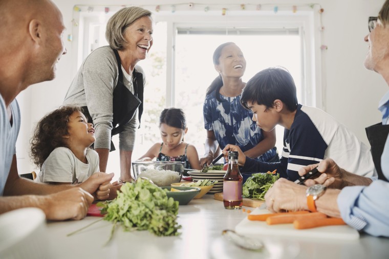 Image: Happy multi-ethnic family preparing Asian food at kitchen