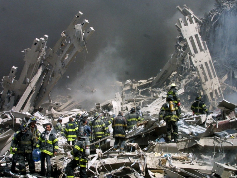 Firefighters make their way through the rubble at the World Trade Center in New York on Sept. 11, 2001.