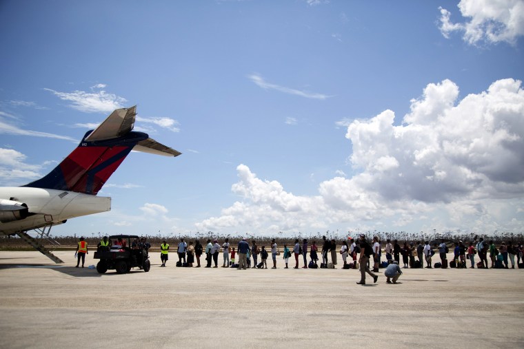 Image: Haitian refugees board a flight to Nassau