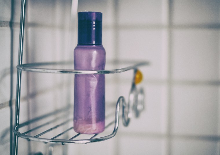 Purple bottle in shower caddy