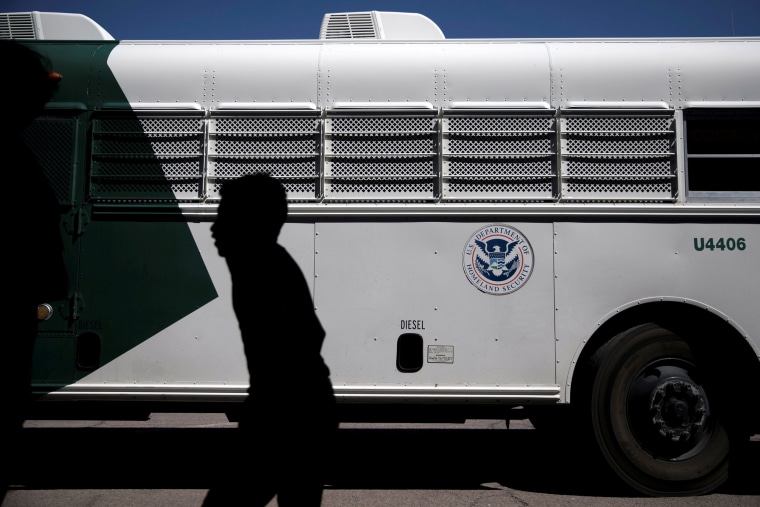 Image: A migrant child disembarks a U.S. Border Patrol bus at the processing center and shelter in Deming