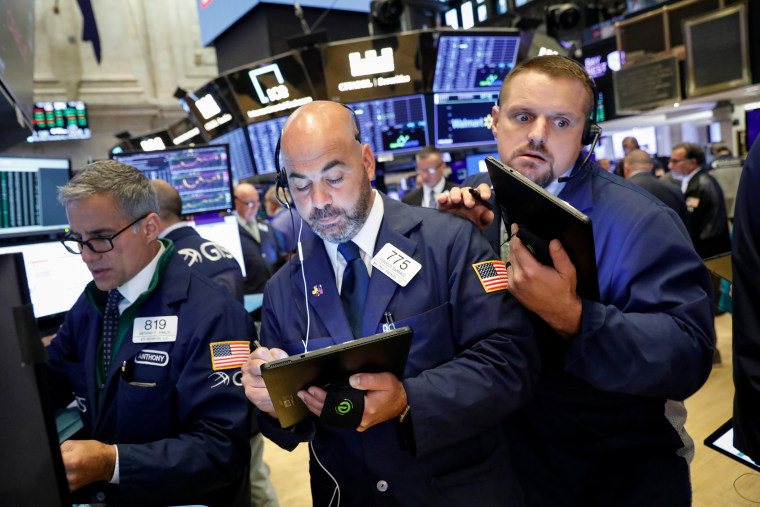 Image: Traders work on the floor at the NYSE in New York