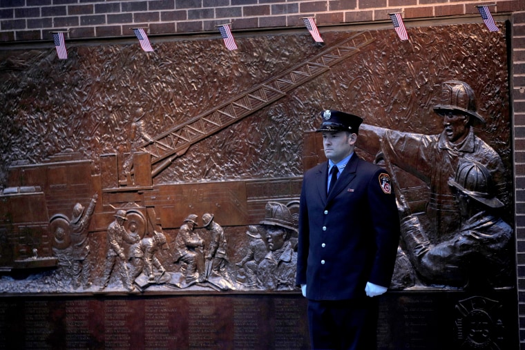 Image: Firefighter outside Firehouse Engine 10 and Ladder 10 on 18th anniversary of the September 11, 2001 attacks at the 911 Memorial in lower Manhattan in New York