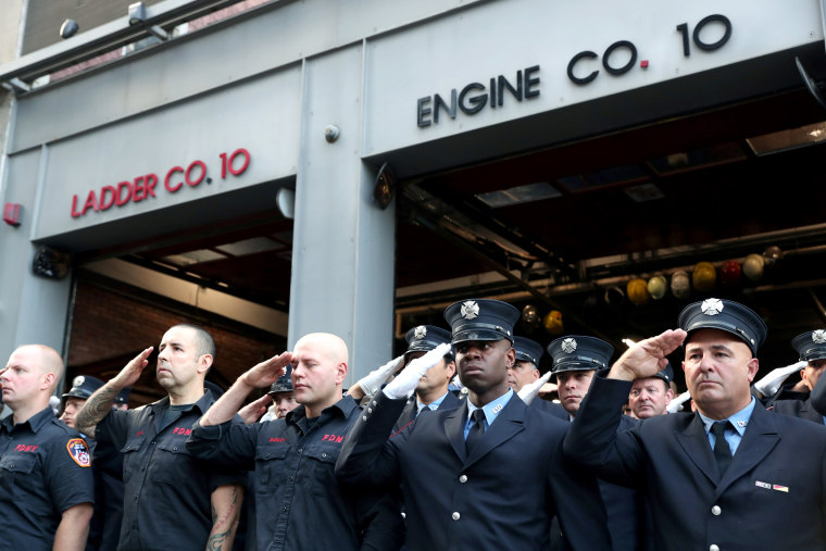 Image: Firefighters stand at attention on the 18th anniversary of the September 11, 2001 attacks in lower Manhattan in New York