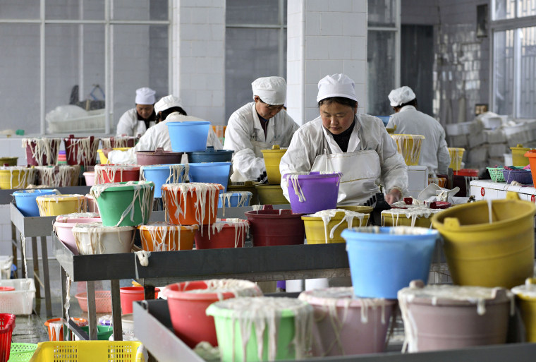 Workers sort pig intestines in a factory in Rugao, China, on