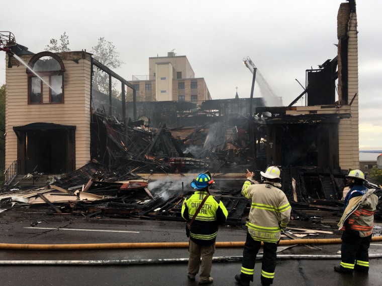 Image: Firefighters investigate the scene after a fire burned down the Adas Israel Congregation in Duluth, Minn., on Sept. 9, 2019.