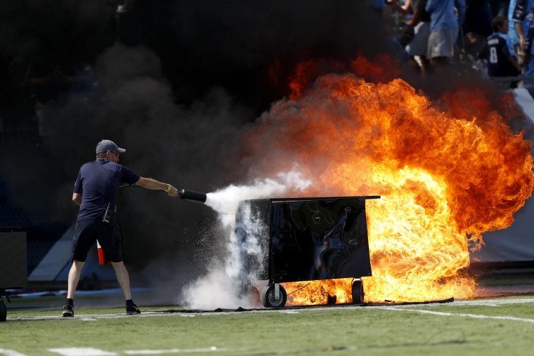Image: A fire from a pyrotechnics machine is extinguished before a football game against the Tennessee Titans and Indianapolis Colts at Nissan Stadium in Tenn. on Sept. 15, 2019.