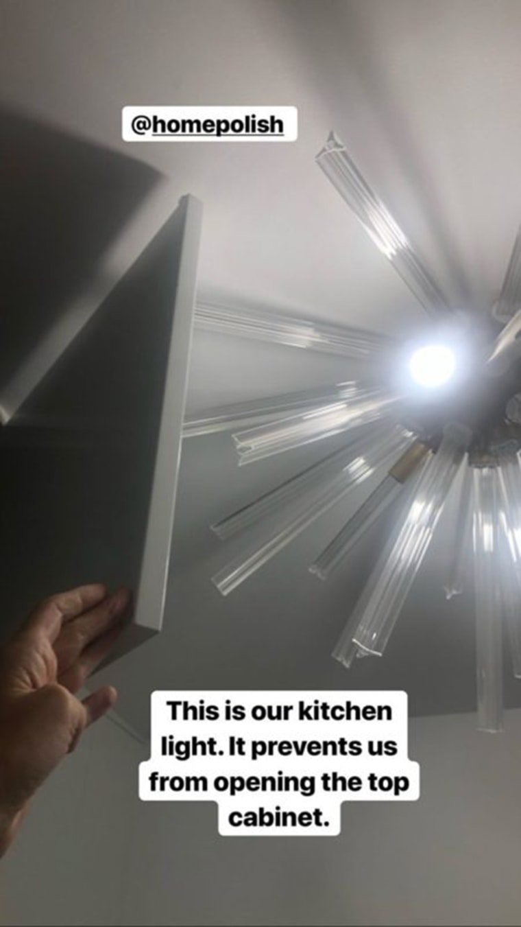 Wiles can't open one of her cabinets in the kitchen because it hits the newly installed light fixture. 