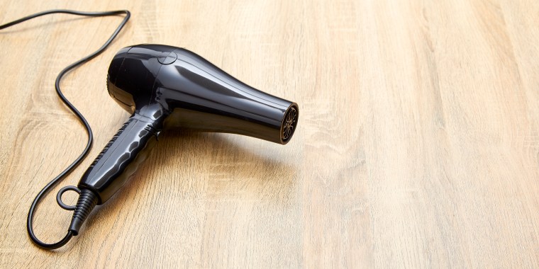 High Angle View Of Hair Dryer On Wooden Table
