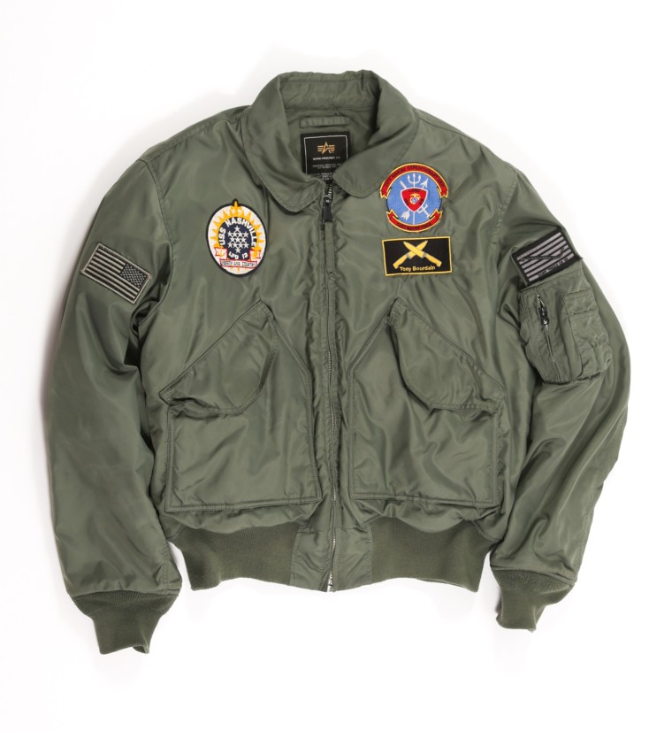 A jacket with patches, including a name patch that has Bourdain's nickname inscribed on it, is one of the items up for auction. 