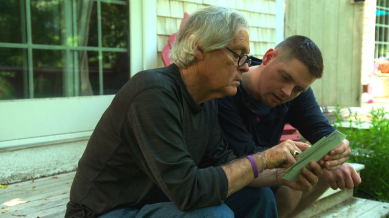 Conor and Greg look through family photos.