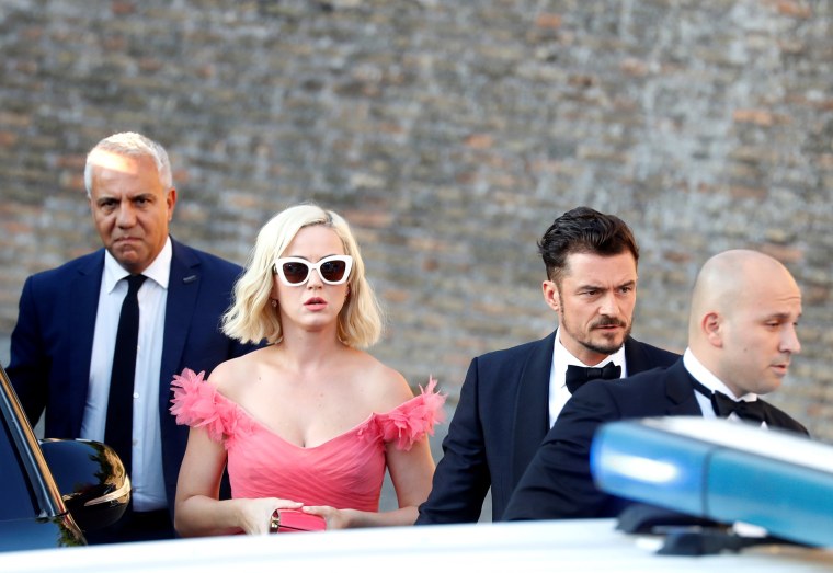 Image: Singer Kate Perry and actor Orlando Bloom arrive to attend the wedding of fashion designer Misha Nonoo at Villa Aurelia in Rome