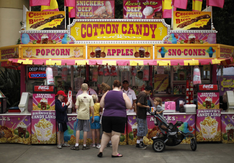 Image: Visitors buy food at the Los Angeles County Fair in Pomona