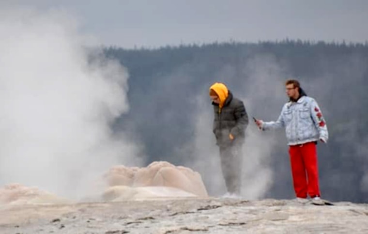 Image: Two men are facing charges after walking on the Old Faithful Geyser at Yellowstone National Park.