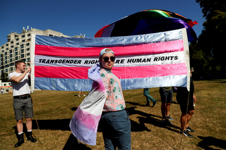 Image: A protester poses in front of a trans flag at the Trans Pride March in London on Sept. 14, 2019.