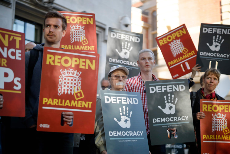 Image: Demonstrators protest outside the Supreme court in central London on the first day of the hearing into the decision by the government to prorogue parliament