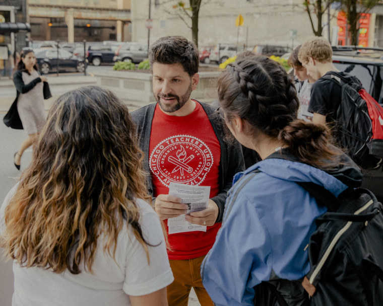 Image: A teacher distributes union flyers in Chicago on Sept. 12, 2019.
