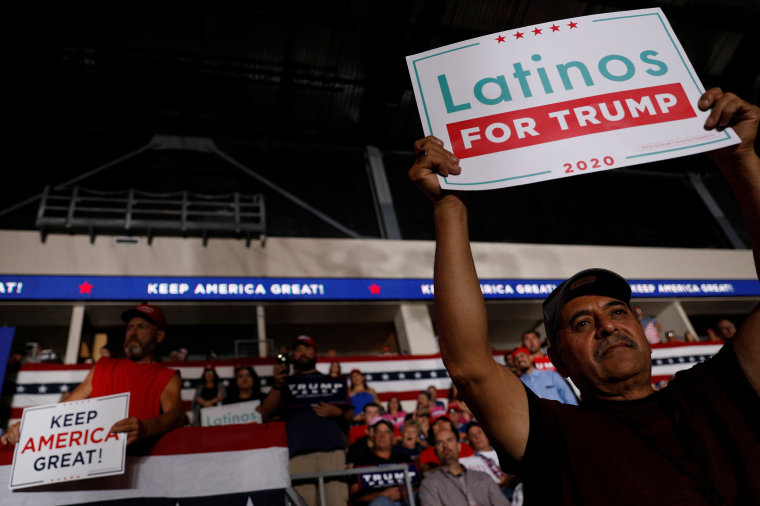 Image: Members of the audience look on as U.S. President Donald Trump delivers remarks at a Keep America Great rally at the Santa Ana Star Center in Rio Rancho, New Mexico