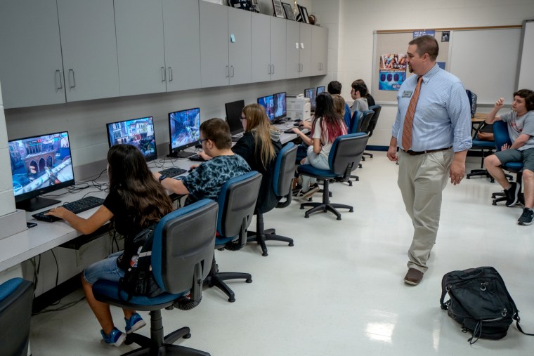 Image: Students at Francis Howell Central High School in St. Louis practice playing Overwatch as guidance counselor and club sponsor looks on.