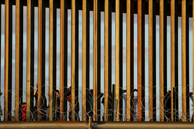 Image: Migrants who crossed illegally into El Paso, Texas, U.S., to turn themselves in to ask for asylum, are pictured behind the border fence as seen from Ciudad Juarez