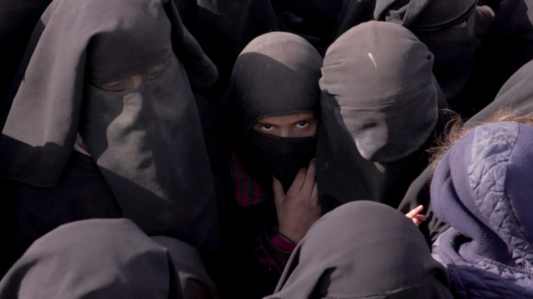 Image: Young women who fled ISIS's final refuge of Baghouz, await food and water handouts in March 2019.