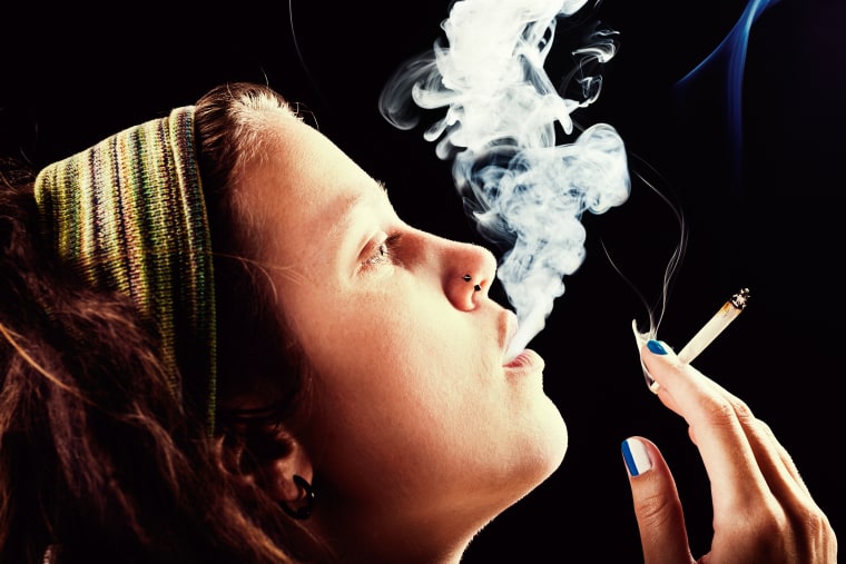Image: A woman smokes pot