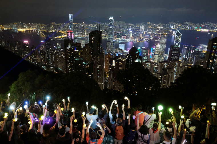 Image: Anti-extradition bill protesters hold hands up to form a human chain during a rally to call for political reforms in Hong Kong