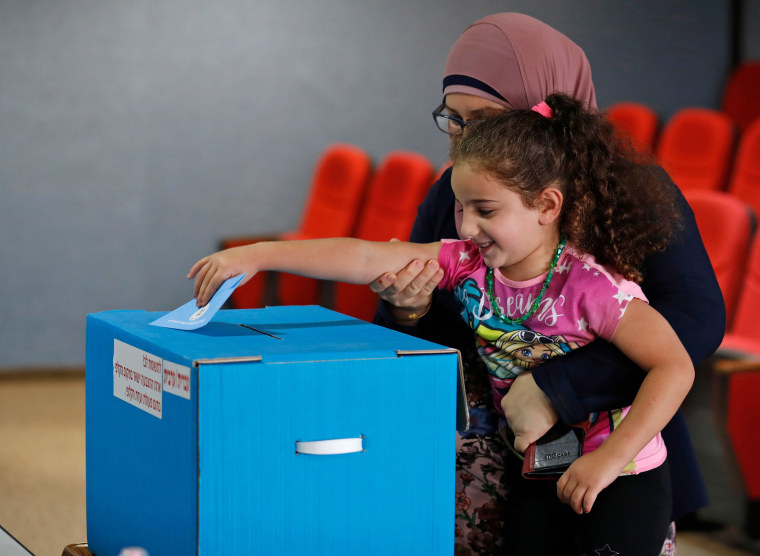 Image: Arab Israelis votes during Israel's parliamentary election at a polling station in Kafr Manda near Haifa