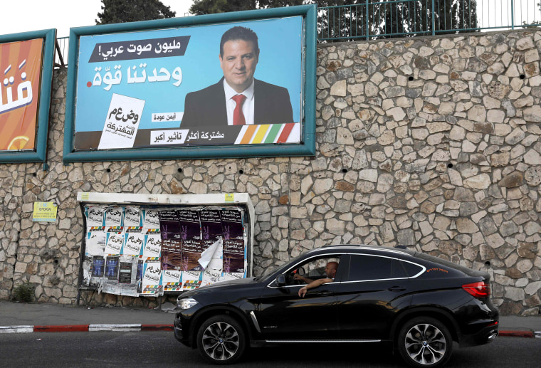 Image: An Arabic-language election banner displaying a picture of Arab Joint List leader Ayman Odehin with a slogans reading: "one million Arab votes, our unity is our strength", in the Israeli city of Nazareth