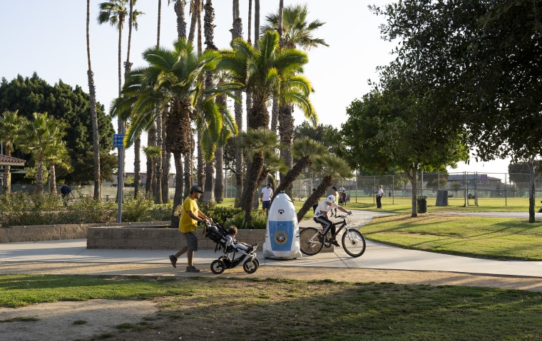 People ride past HP RoboCop in Salt Lake Park, Los Angeles on Sept. 19, 2019.