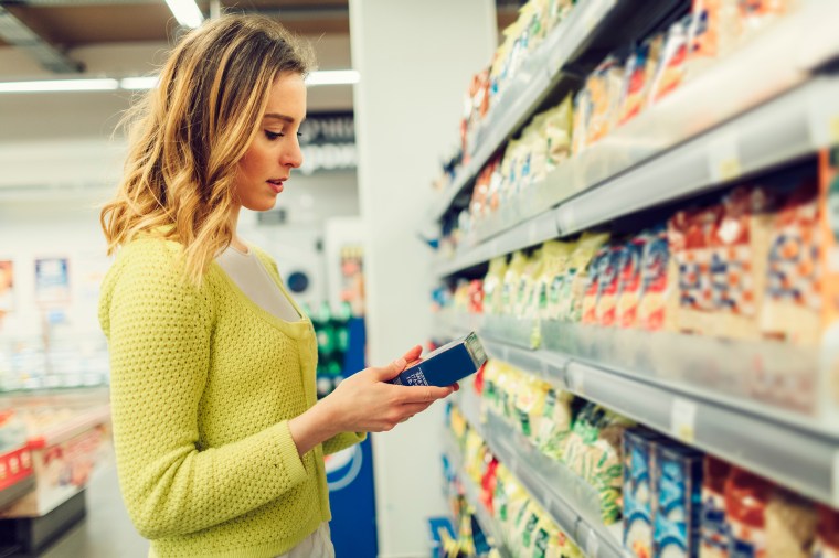 Young Woman Groceries Shopping In Local Supermarket.