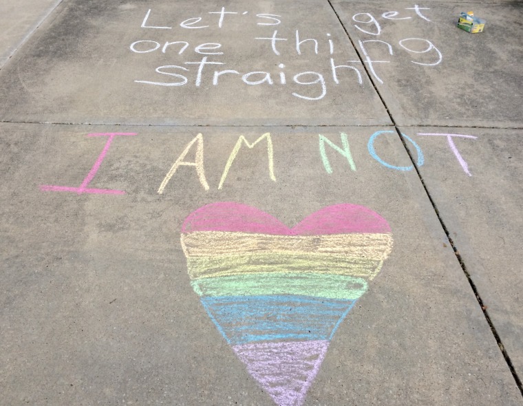 16-year-old Anna Christmas announced to her community that she identifies as panromantic and asexual by drawing a rainbow sidewalk chalk drawing in her driveway.