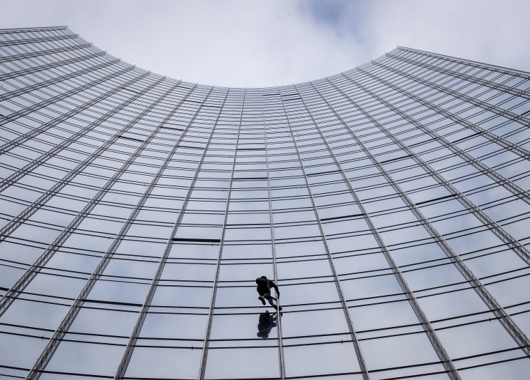 It took Robert only 20 minutes to push and pull his way to its rooftop.