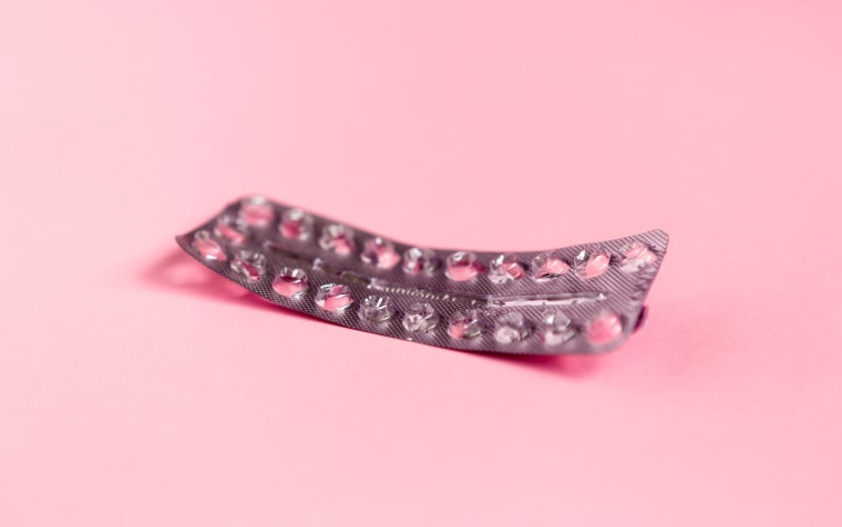 Image: Empty strip of birth control pills on pink