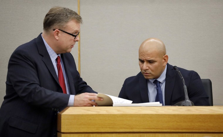 Image: Policeman Martin Rivera, right, looks as Assistant District Attorney Jason Hermus shows him his texts and Snapchat records as he testifies on the witness stand