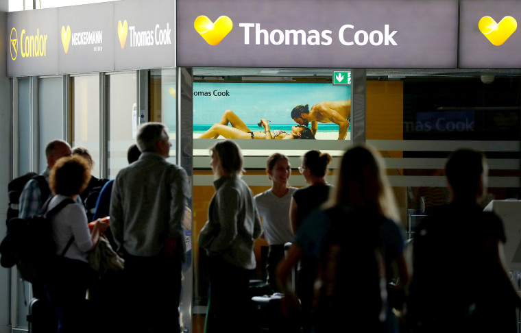 Image: Passengers are silhouetted in front of a closed service counter of travel agent Thomas Cook and airline Condor at the airport  in Frankfurt