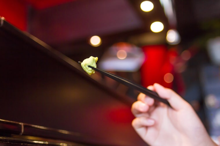 Person Eating Wasabi With Chopsticks
