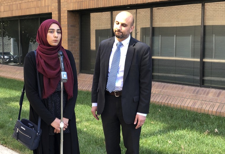 Image: Lawyer Gadier Abbas listens to his client, Shain Indorewala, speak at a press conference about her religious discrimination lawsuit in Falls Church, Va., on Sept. 25, 2019.