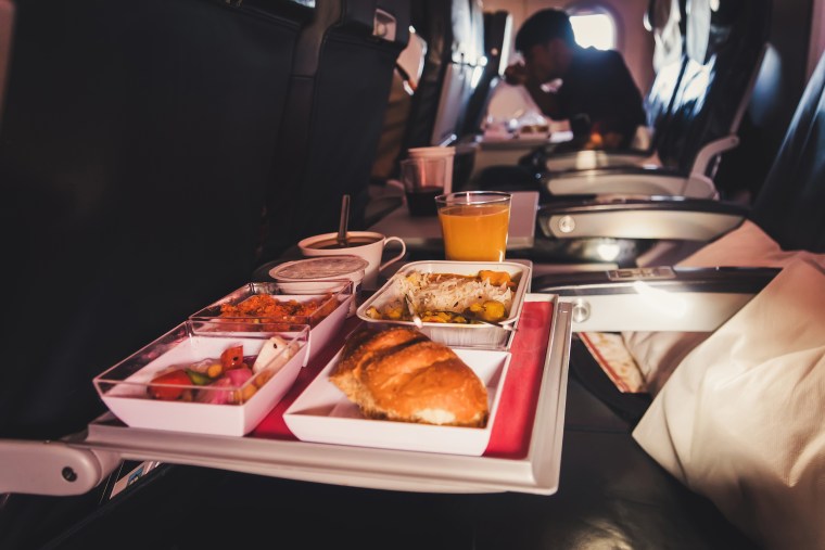 Lunch in airplane. Inflight economy class meal on tray