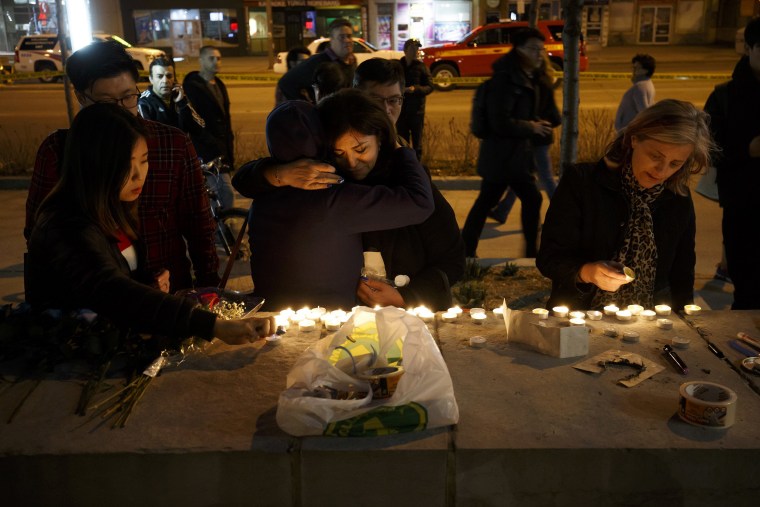 Image: People embrace as they lay candles and leave messages at a memorial for victims of a crash on Yonge St. at Finch Ave., after a van plowed into pedestrians on April 23, 2018 in Toronto, Canada.