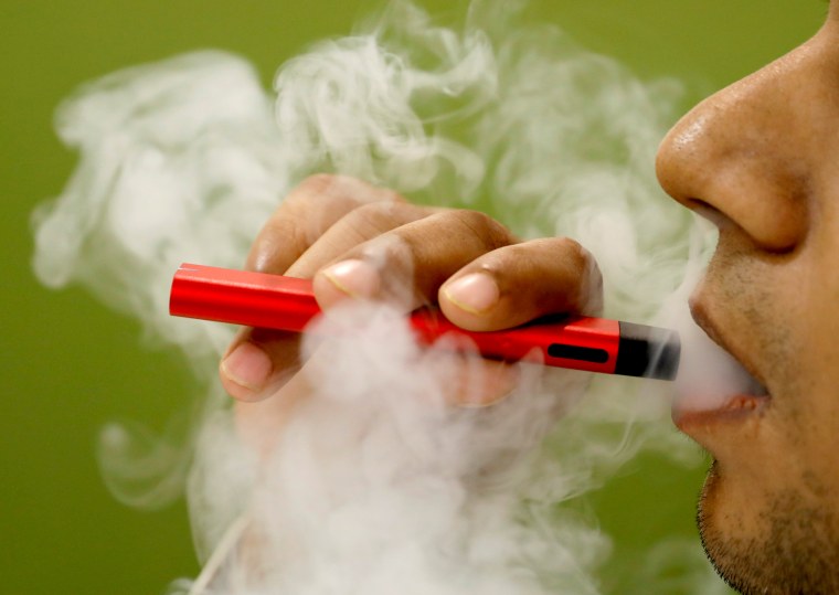 Image: FILE PHOTO: A man uses a vape device in this illustration picture
