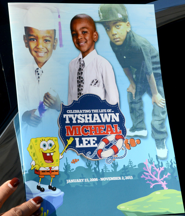 A mourner holds the program for the funeral of 9-year-old Tyshawn Lee at St. Sabina Church on Nov. 10, 2015 in Chicago.